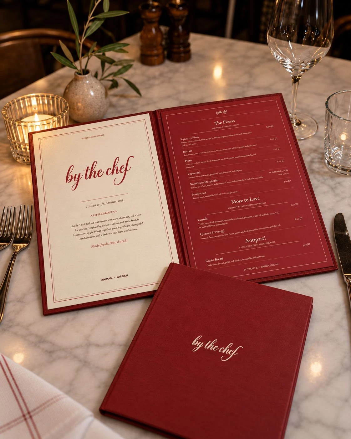 By The Chef menu folder on a marble table