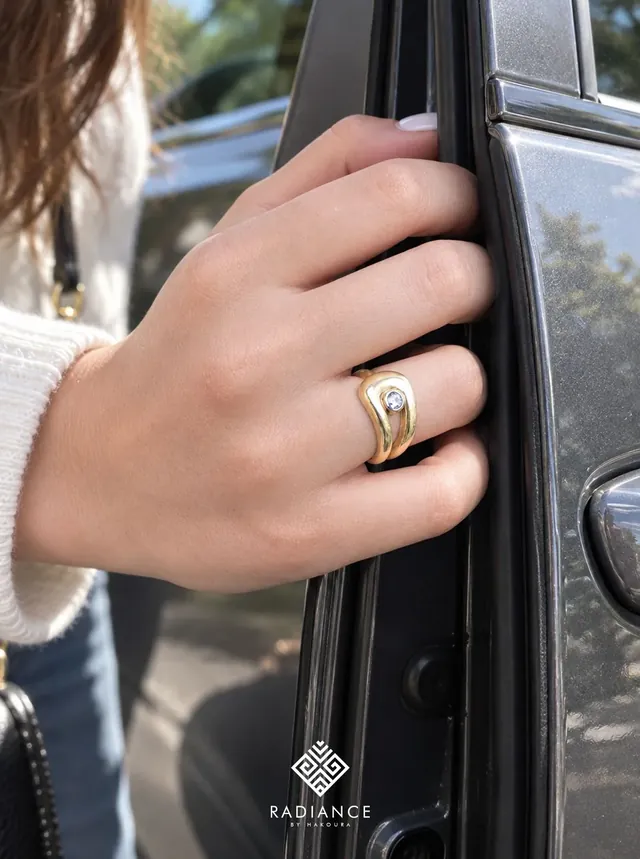 Radiance by Hakoura — gold ring on a car door