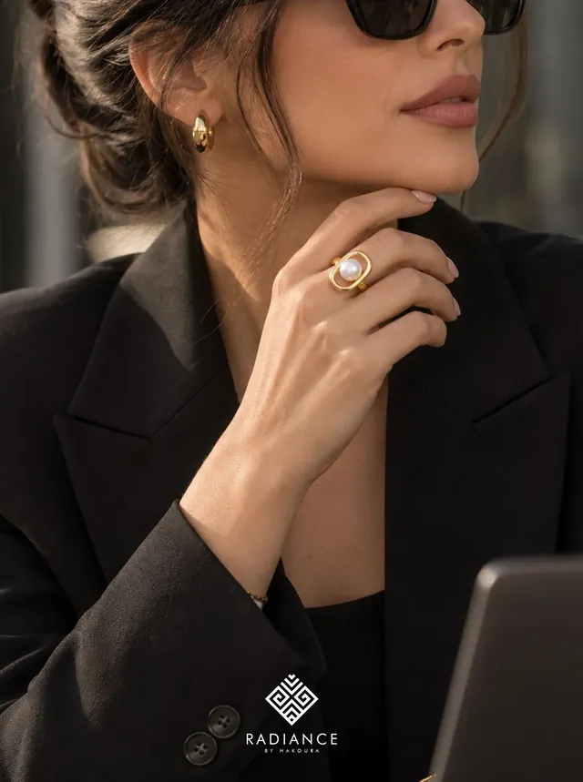 Radiance by Hakoura — woman in a black blazer wearing the gold ring